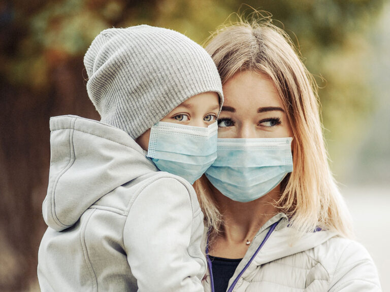 Parent and child wearing protective face masks