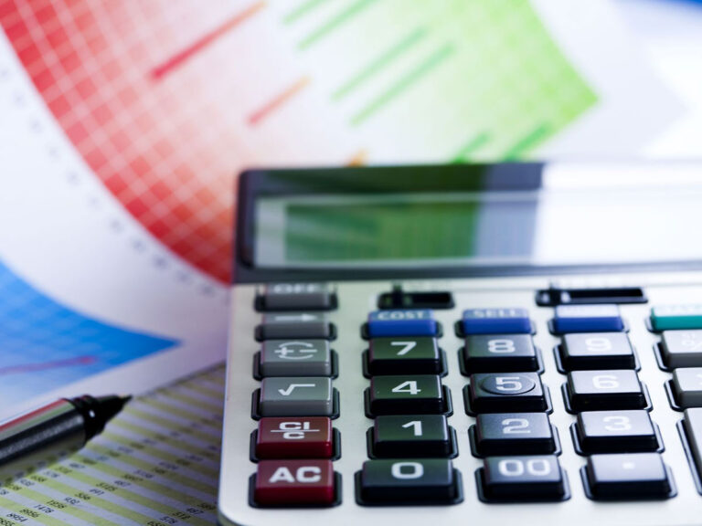 Calculator in front of printed graphs