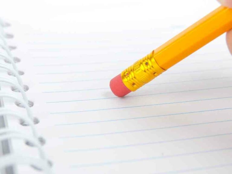 Pencil eraser above lined paper