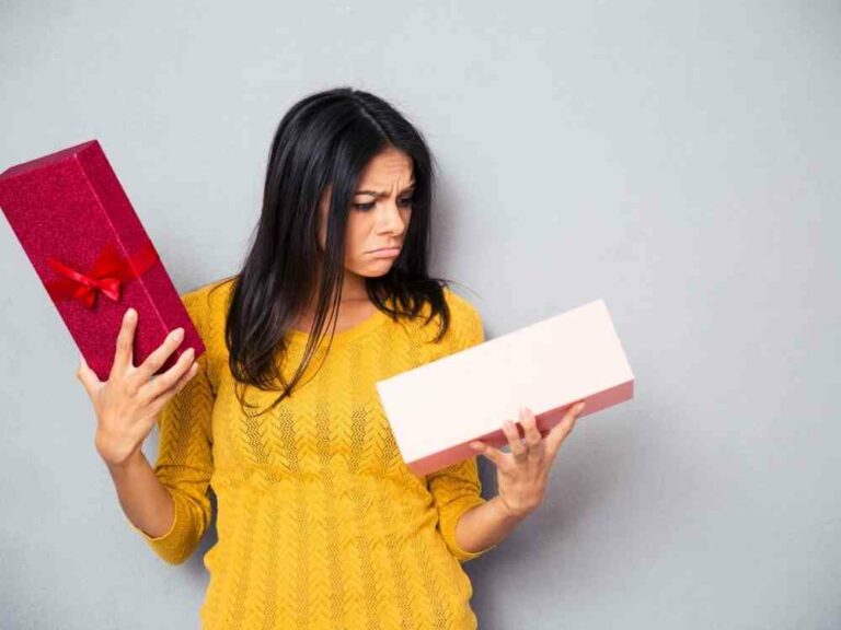 Unhappy woman looking in box