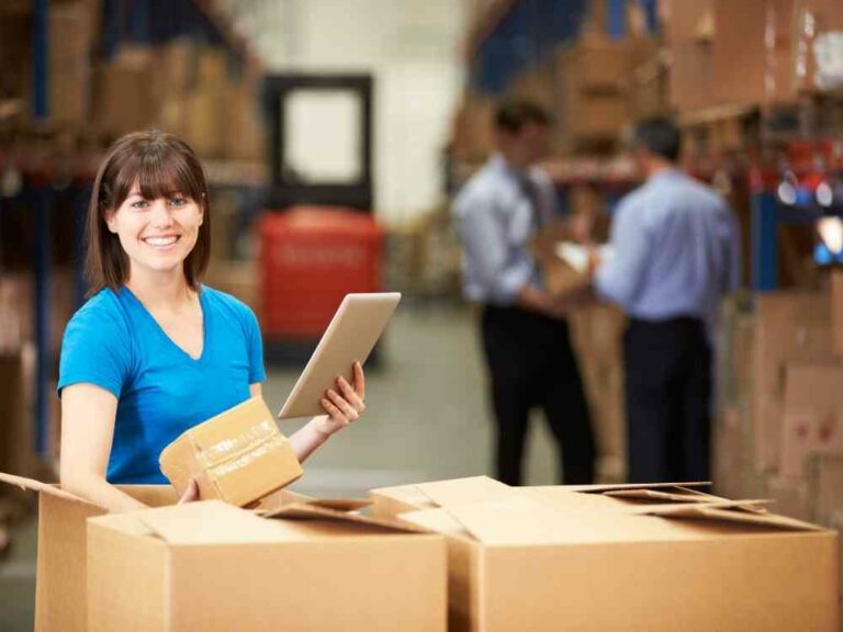 Woman in warehouse packing boxes